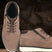 A taupe Men's bugatti Sneakers featuring a round toe plain toe, zero heels heel, and a wide fit. Made from premium genuine leather with a durable tpr outsole, this zipper design offers both style and comfort.