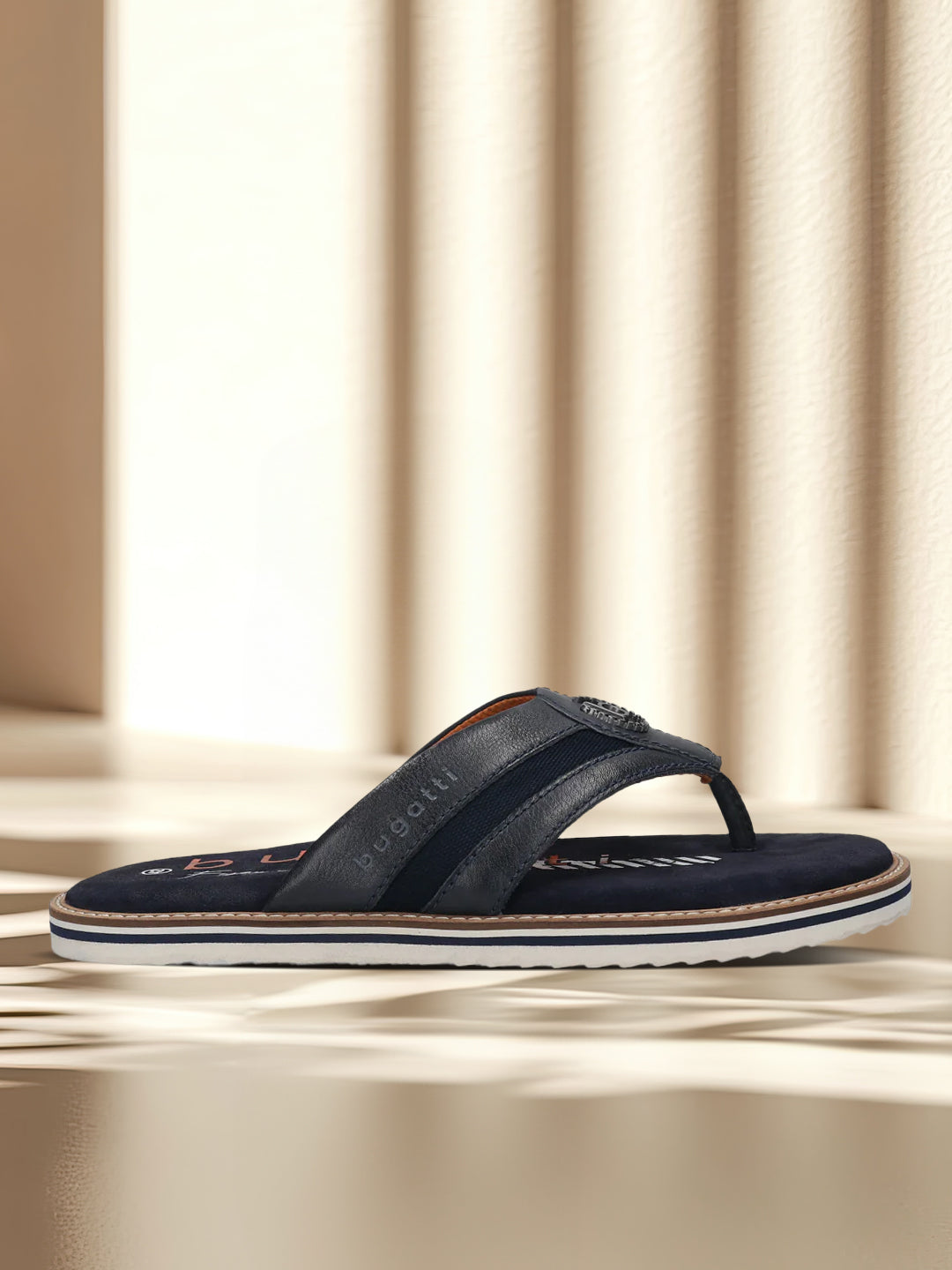 A blue Men's bugatti Thongs featuring a round open toe, zero heels heel, and a wide fit. Made from premium genuine leather with a durable eva outsole, this slip-on design offers both style and comfort.