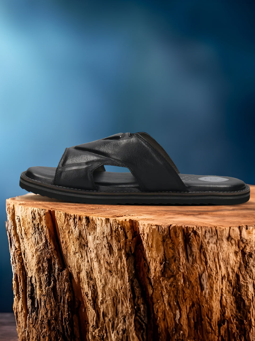 A black Men's bugatti Mules featuring a round toe plain toe, zero heels heel, and a wide fit. Made from premium genuine leather with a durable eva outsole, this slip-on design offers both style and comfort.