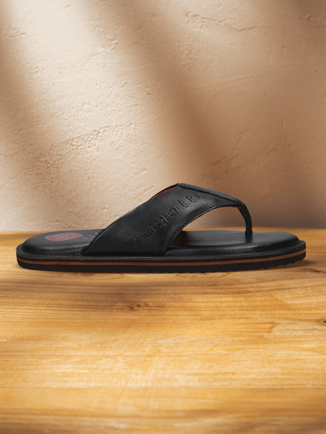 A black Men's bugatti Thongs featuring a open toe plain toe, zero heels heel, and a wide fit. Made from premium genuine leather with a durable eva outsole, this slip-on design offers both style and comfort.