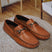 Men's Bugatti drivers cognac leather shoes with a round toe and apron toe , a rubber outsole.