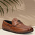 A cognac Men's bugatti Drivers featuring a round toe apron toe, zero heels heel. Made from premium genuine leather with a durable rubber outsole, this slip-on design offers both style and comfort.