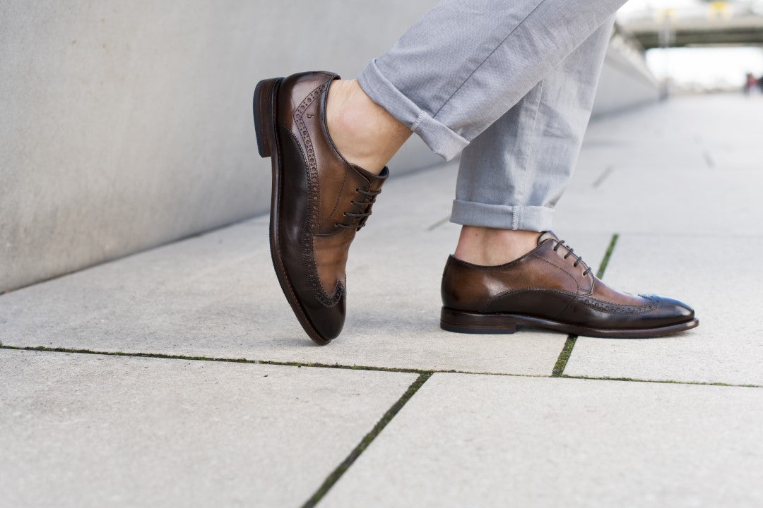 A brown Men's bugatti Brogue featuring a round wingcap, stacked heel. Made from premium genuine leather with a durable leather outsole, this laces design offers both style and comfort.