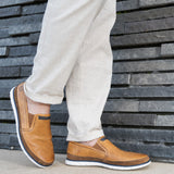 A cognac Men's bugatti Casual Loafers featuring a round plain toe, zero heels heel. Made from premium genuine leather with a durable tr outsole, this slip-on design offers both style and comfort.