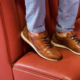A cognac Men's bugatti Sneakers featuring a round plain toe, zero heels heel. Made from premium genuine leather with a durable tr outsole, this slip-on design offers both style and comfort.