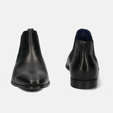 A black Men's bugatti Chelsea Boots featuring a round toe plain toe, stacked heel. Made from premium genuine leather with a durable tpr outsole, this elastic design offers both style and comfort.
