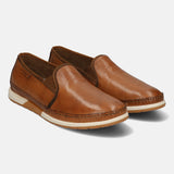 A brown Men's bugatti Slip-On Sneakers featuring a round toe plain toe, zero heels heel. Made from premium genuine leather with a durable tpr outsole, this slip-on design offers both style and comfort.