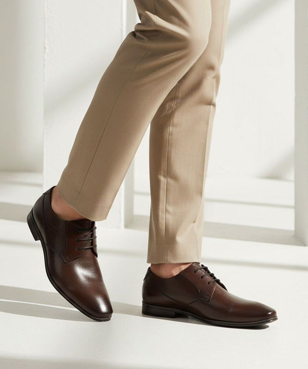 bugatti Morino I dark brown premium leather derby formal shoes, styled with tan trousers.
