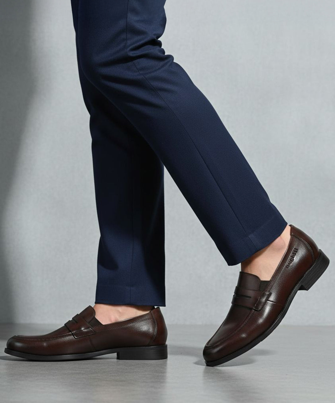bugatti Theobaldo dark brown premium leather penny loafers, complemented by navy dress pants.
