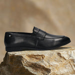 Men's Bugatti penny loafer black leather shoes with a pointed toe and apron toe featuring a stacked heel , a tpr outsole.