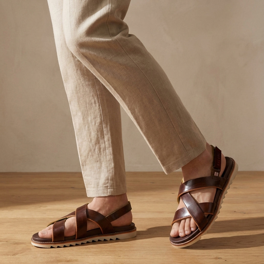 Lifestyle shot of bugatti Limon dark brown premium leather sandals with comfort back strap.
