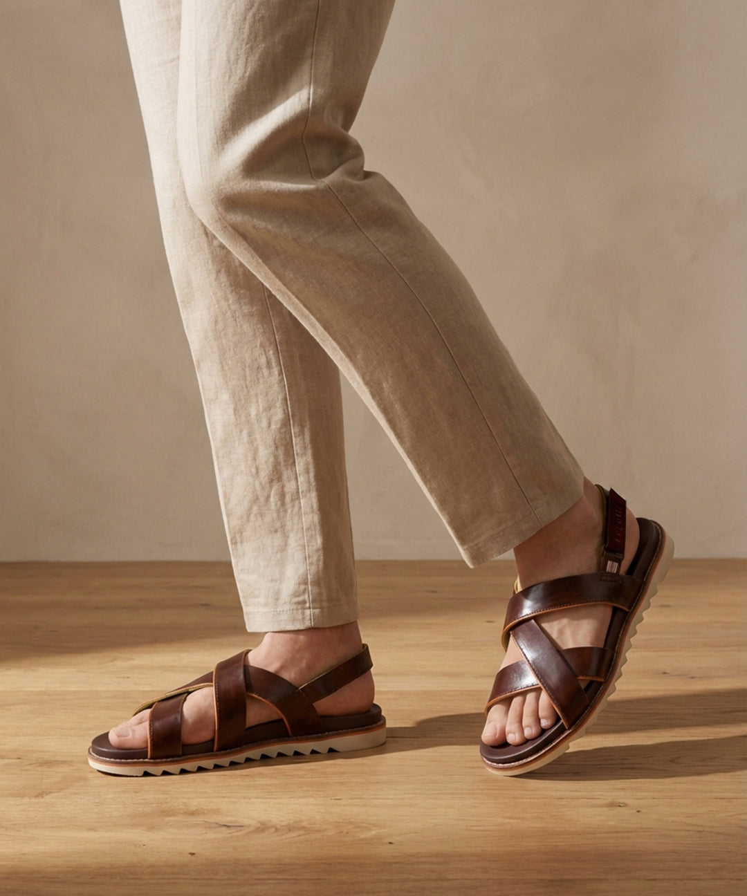 Lifestyle shot of bugatti Limon dark brown premium leather sandals with comfort back strap.

