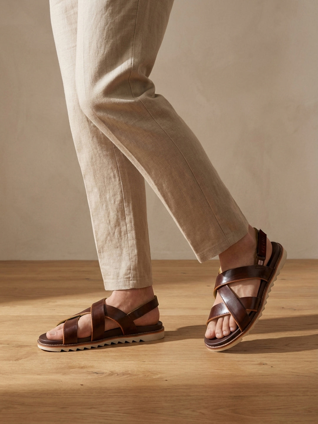 Lifestyle shot of bugatti Limon dark brown premium leather sandals with comfort back strap.

