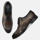 Men's Bugatti derby grey leather shoes with a round toe and wing tip featuring a stacked heel , a leather outsole , and laces fastening.