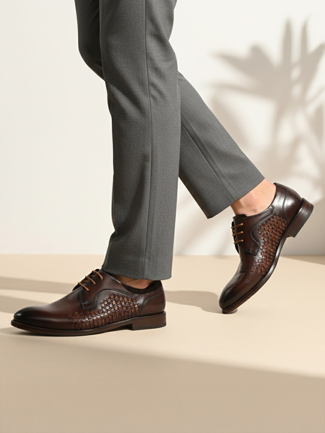 bugatti Livorno Flex Evo dark brown leather formal derby shoes with woven texture, paired with grey dress pants.