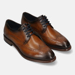 Men's Bugatti derby cognac leather shoes with a round toe and wing tip featuring a stacked heel , a leather outsole , and laces fastening.