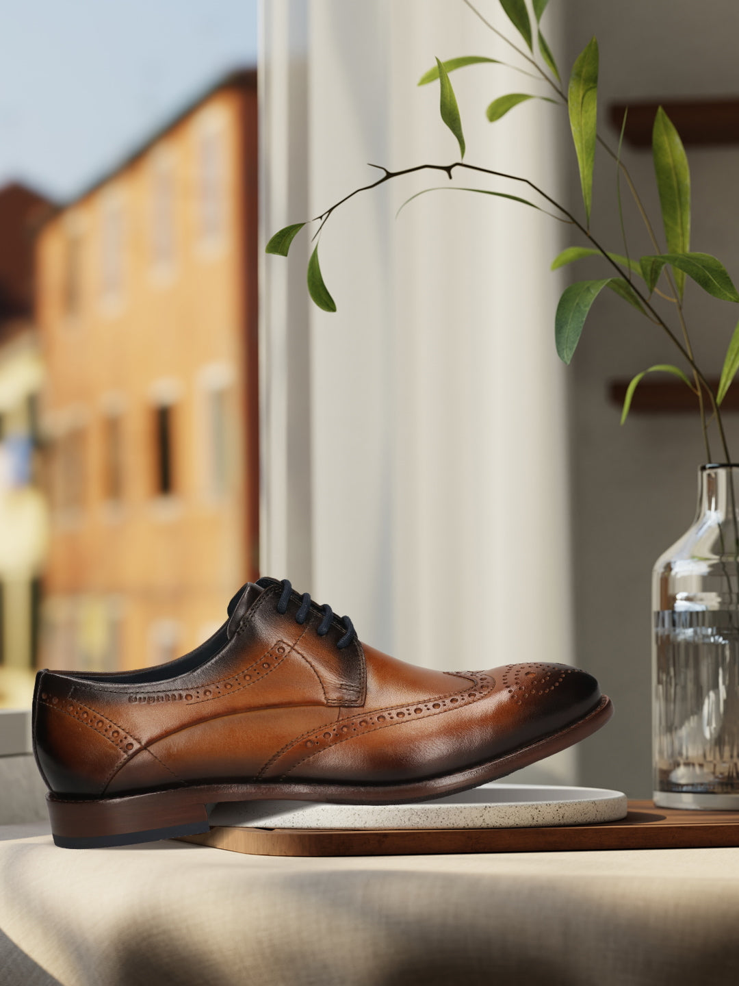 Men's Bugatti derby cognac leather shoes with a round toe and wing tip featuring a stacked heel , a leather outsole , and laces fastening.