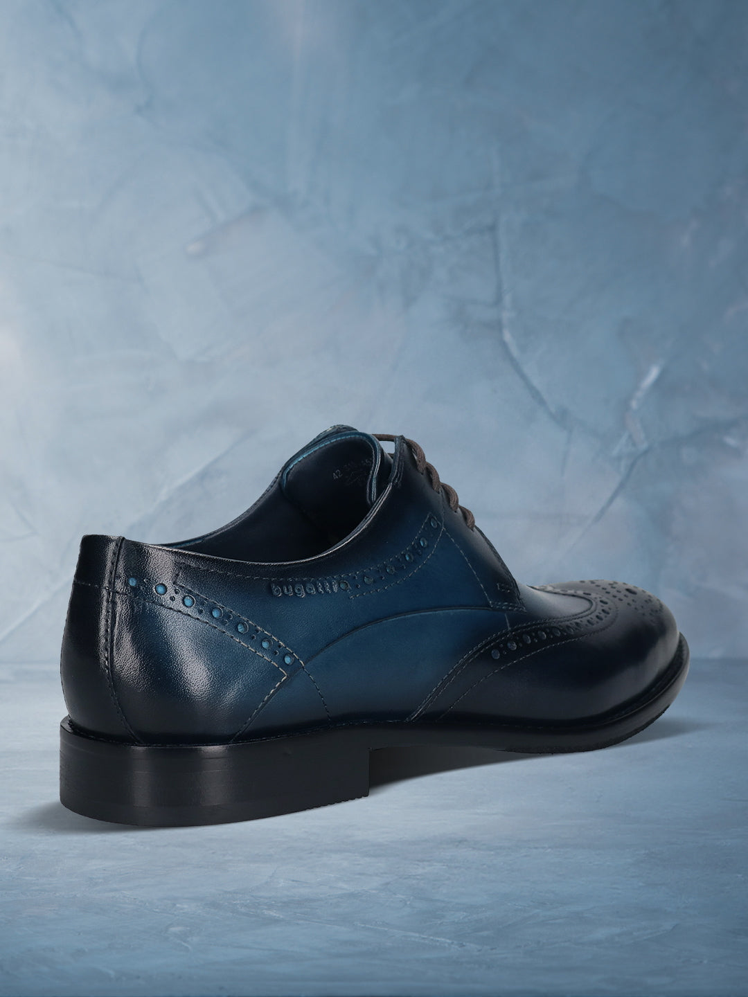 Men's Bugatti derby blue leather shoes with a round toe and wing tip featuring a stacked heel , a leather outsole , and laces fastening.