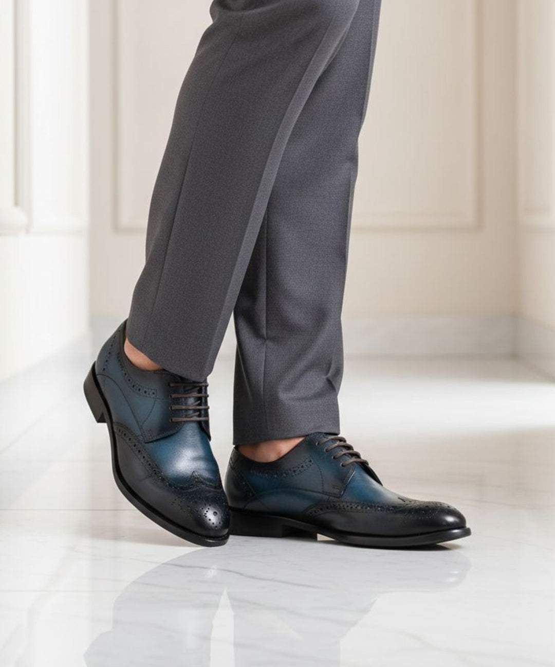 bugatti Livorno Flex Evo dark blue leather derby shoes with black accents, styled with gray dress pants.
