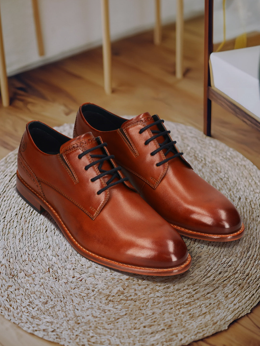 Men's Bugatti derby cognac leather shoes with a round toe and plain toe featuring a stacked heel , a leather outsole , and laces fastening.