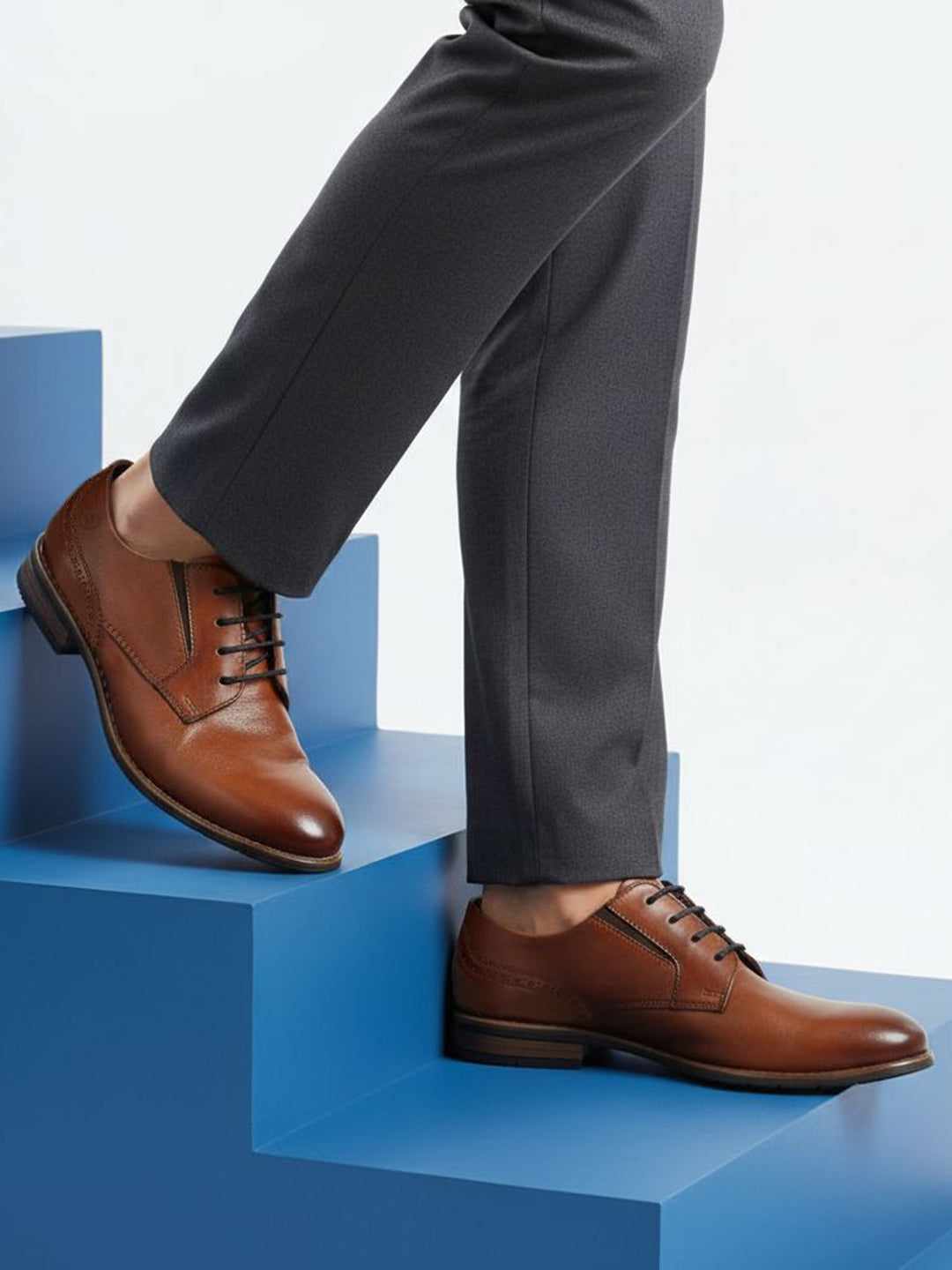bugatti Livorno Flex Evo cognac leather derby shoe with black laces on blue steps.