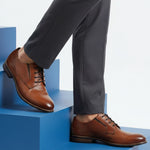 bugatti Livorno Flex Evo cognac leather derby shoe with black laces on blue steps.