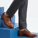 bugatti Livorno Flex Evo cognac leather derby shoe with black laces on blue steps.