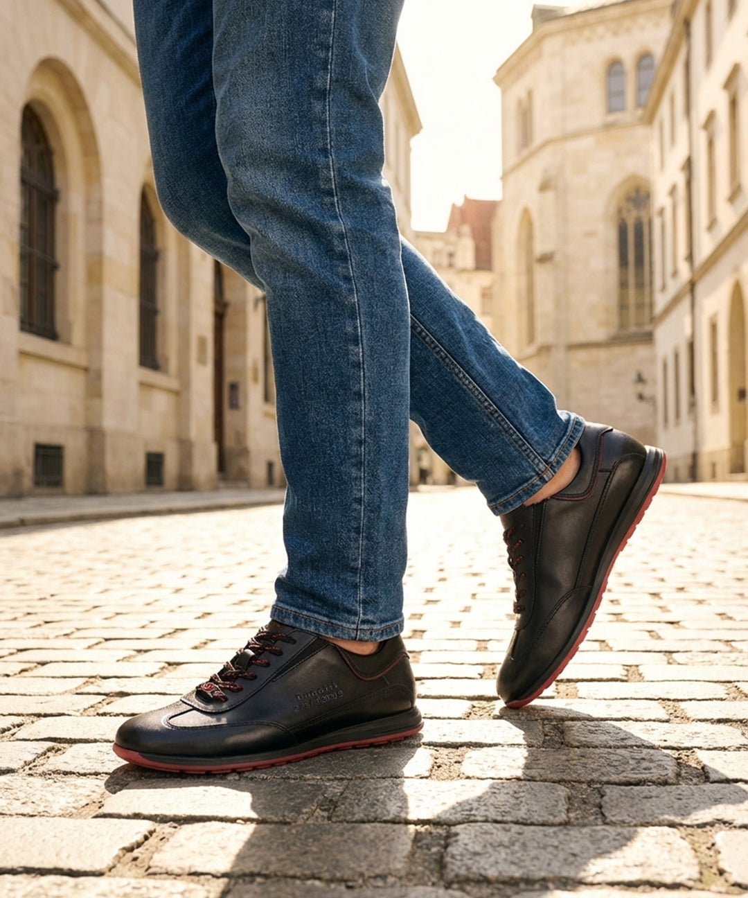 Person wearing black Men's bugatti Sneakers featuring a round plain toe, zero heels heel. Made from premium genuine leather with a durable tr outsole.