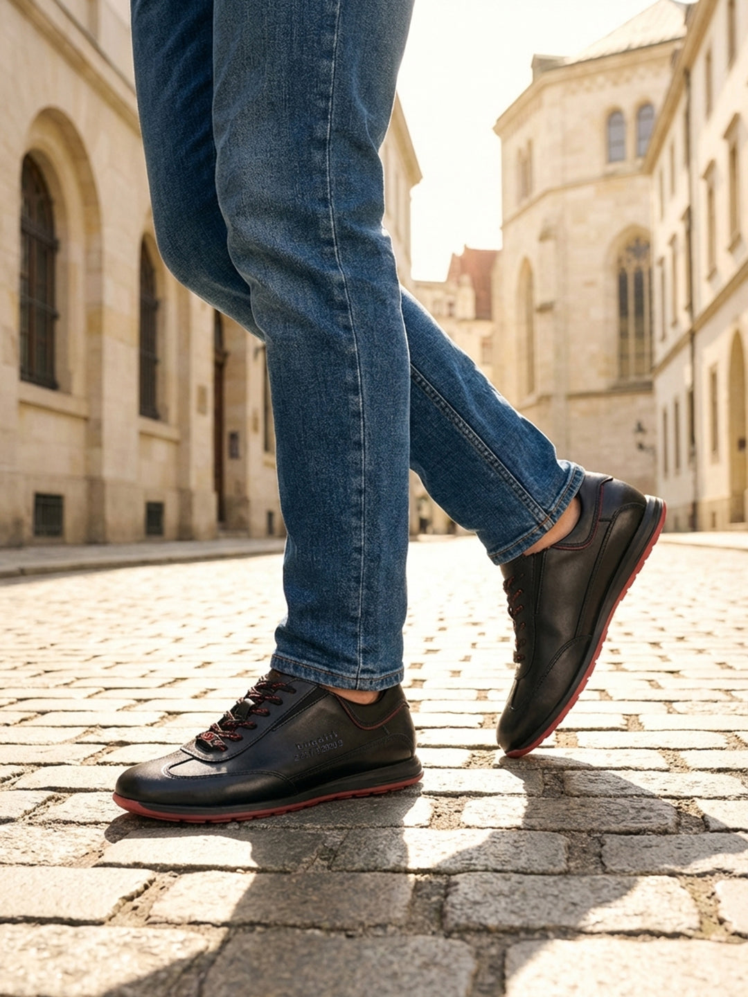 Person wearing black Men's bugatti Sneakers featuring a round plain toe, zero heels heel. Made from premium genuine leather with a durable tr outsole.