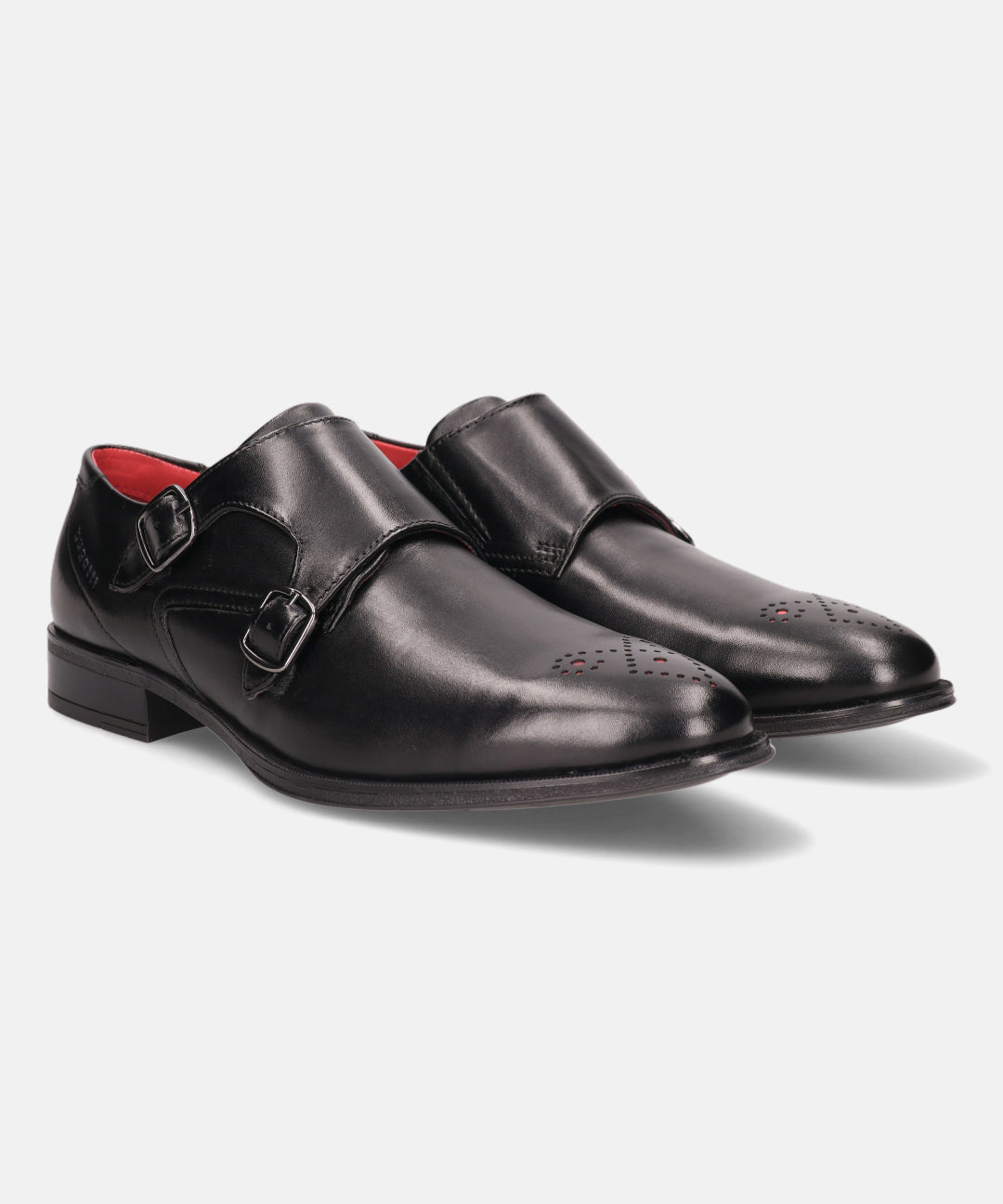 Black premium leather monk shoes by bugatti with double buckle straps and decorative perforations.