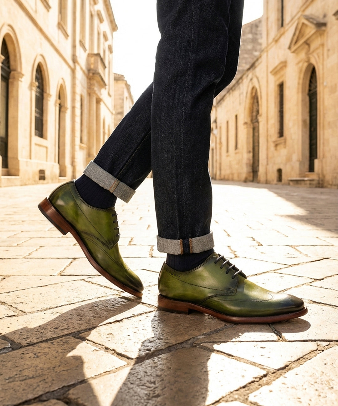 bugatti Mansaro green leather derby shoes with a dark brown sole, paired with cuffed denim jeans.
