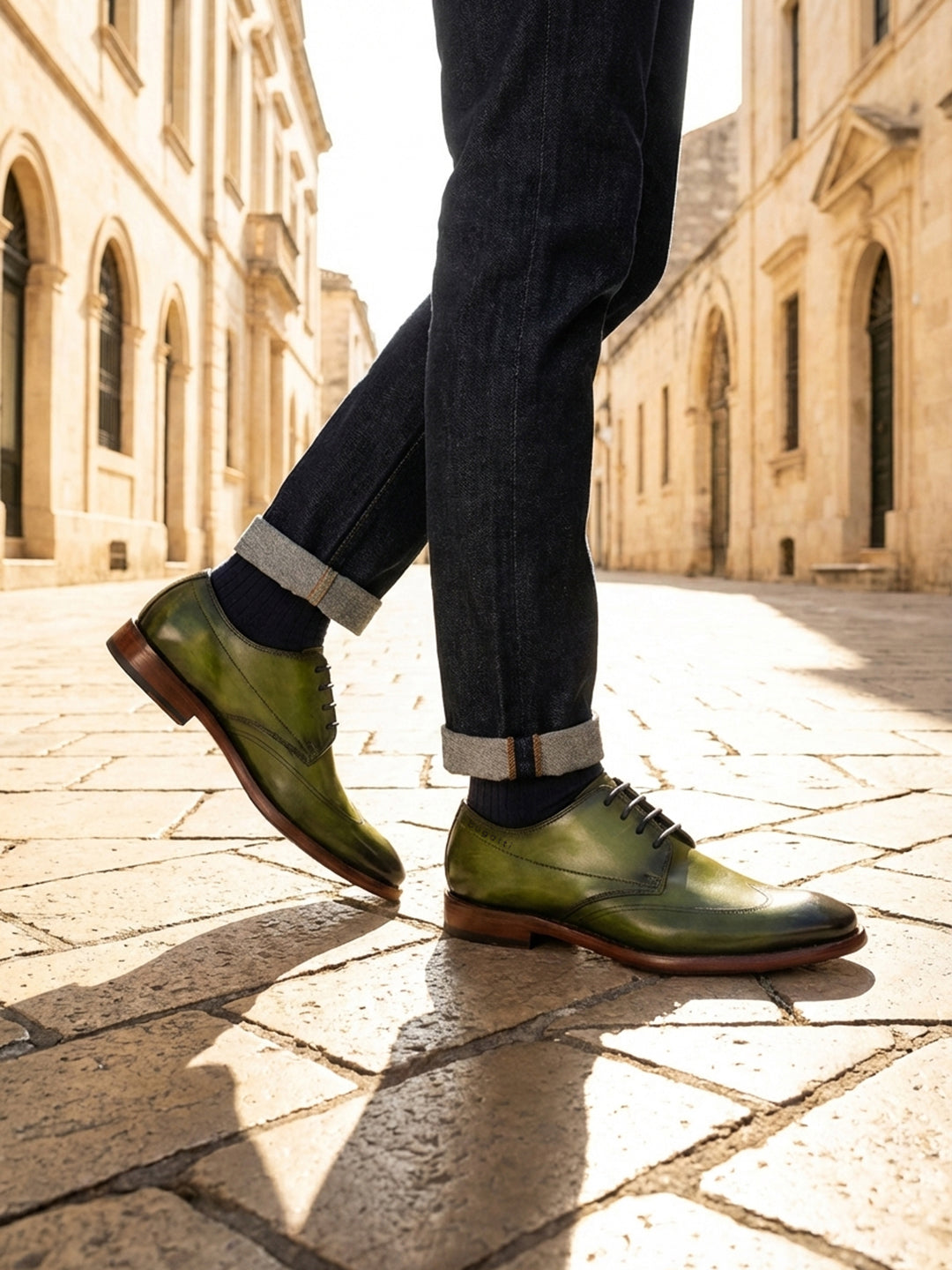 bugatti Mansaro green leather derby shoes with a dark brown sole, paired with cuffed denim jeans.
