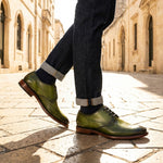 bugatti Mansaro green leather derby shoes with a dark brown sole, paired with cuffed denim jeans.
