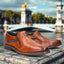 A cognac Men's bugatti Venetian Loafers featuring a round cap toe, moulded  heel, and a wide fit. Made from premium genuine leather with a durable tr outsole, this zipper design offers both style and comfort.