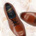 Men's Bugatti derby cognac leather shoes with a round toe and plain toe featuring a stacked heel , a tpr outsole , and laces fastening.