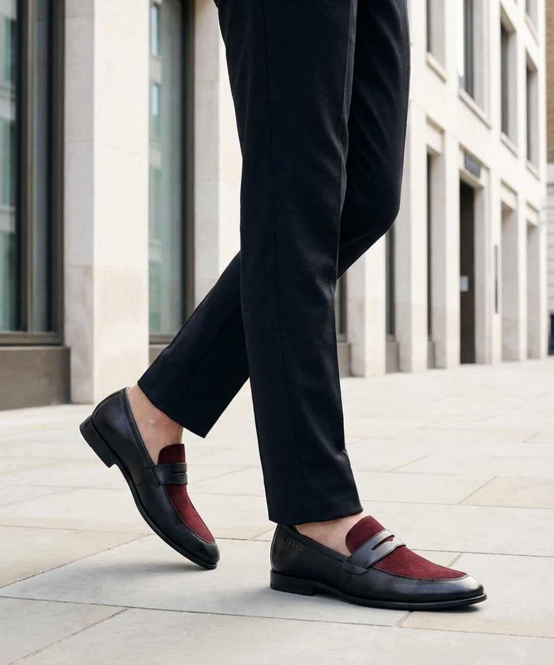 Lifestyle image of bugatti Rico black leather penny loafers with a burgundy suede accent.