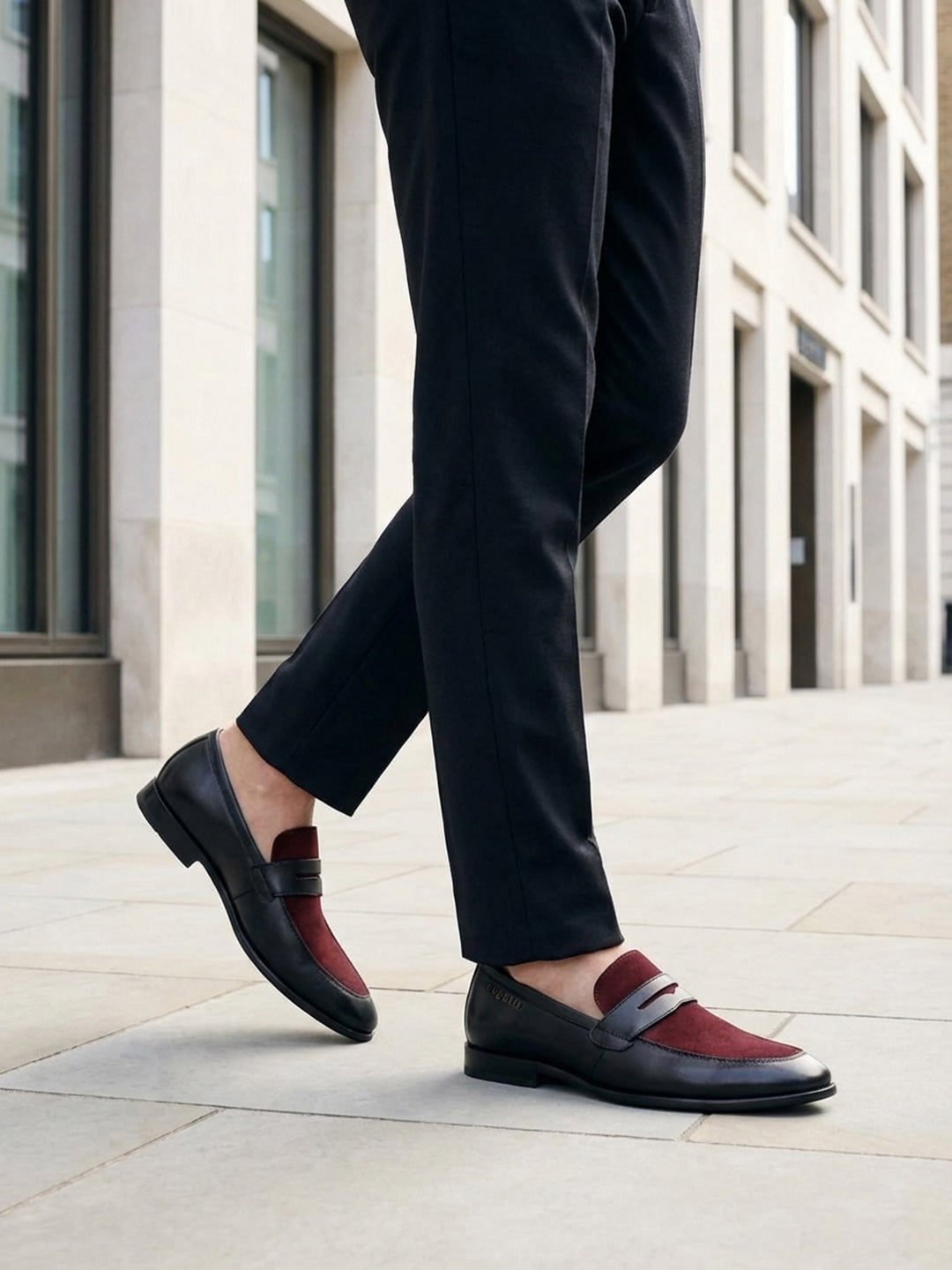 Lifestyle image of bugatti Rico black leather penny loafers with a burgundy suede accent.