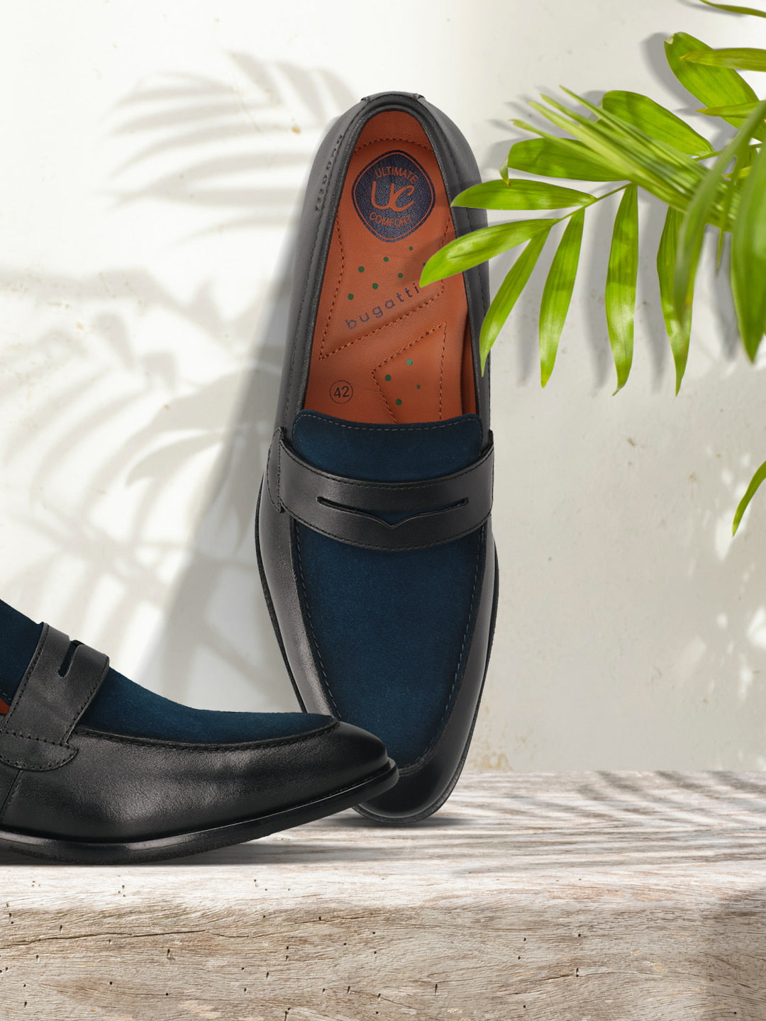 Men's Bugatti penny loafer black leather shoes with a round toe and apron toe featuring a stacked heel , a leather outsole.