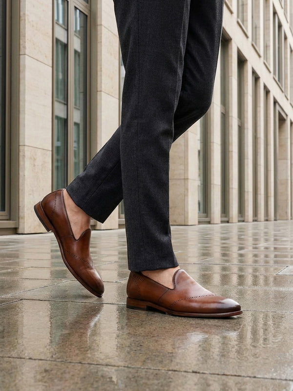 Lifestyle shot of bugatti Rico cognac premium leather slip-on formal shoes with a classic style.