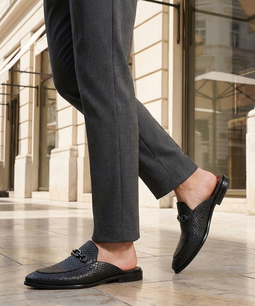bugatti Rico black leather slip-on dress shoes with basket weave texture and a metal buckle.
