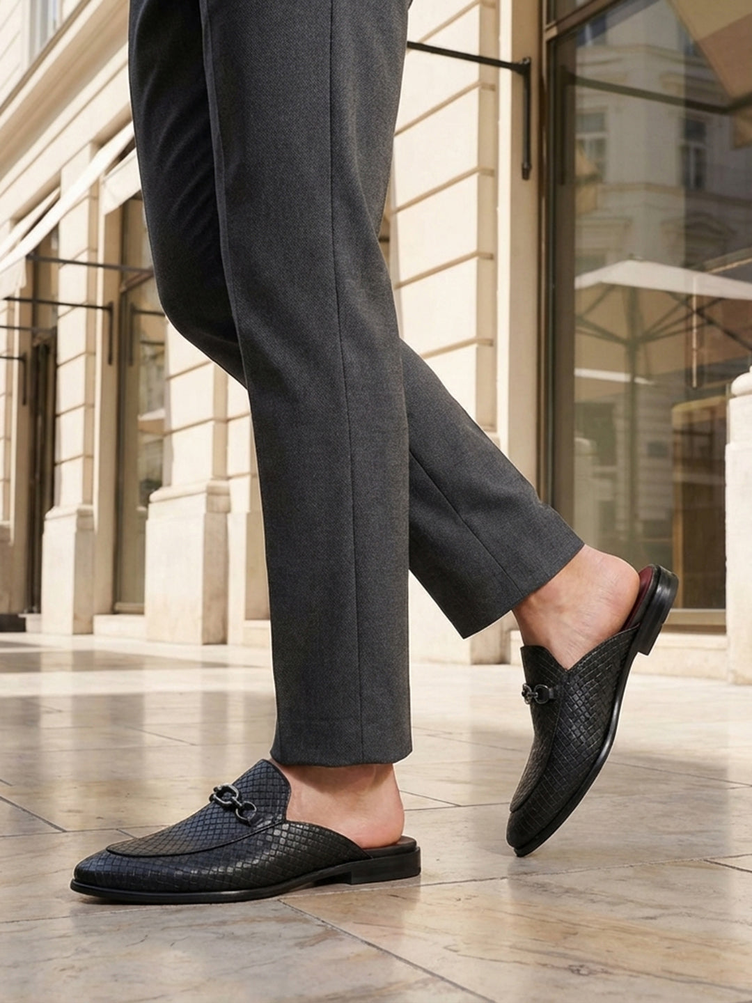 bugatti Rico black leather slip-on dress shoes with basket weave texture and a metal buckle.
