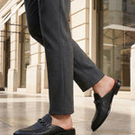 bugatti Rico black leather slip-on dress shoes with basket weave texture and a metal buckle.
