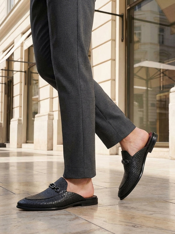 bugatti Rico black leather slip-on dress shoes with basket weave texture and a metal buckle.
