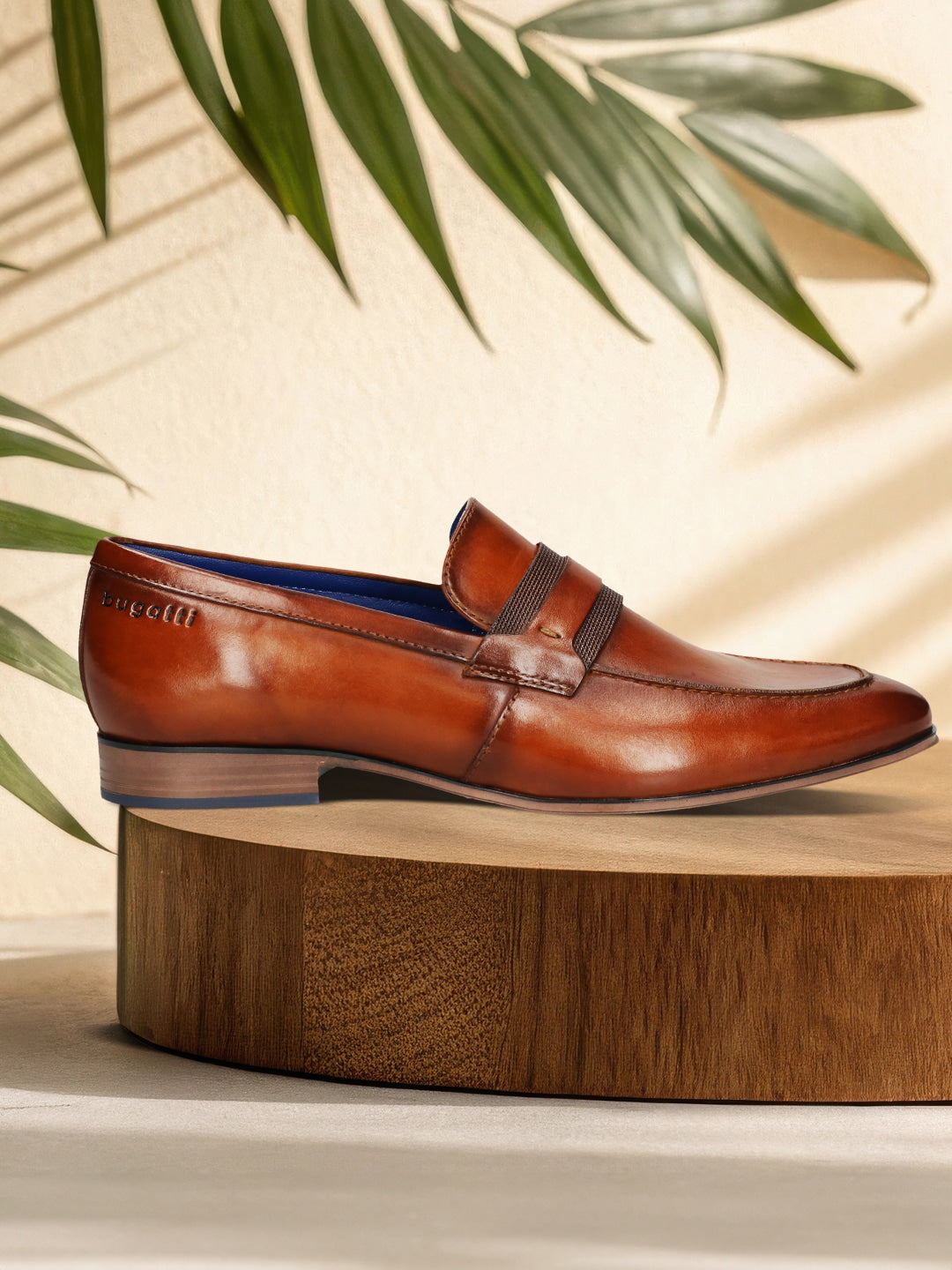 Men's Bugatti penny loafer cognac leather shoes with a round toe and apron toe featuring a moulded heel , a pvc outsole.