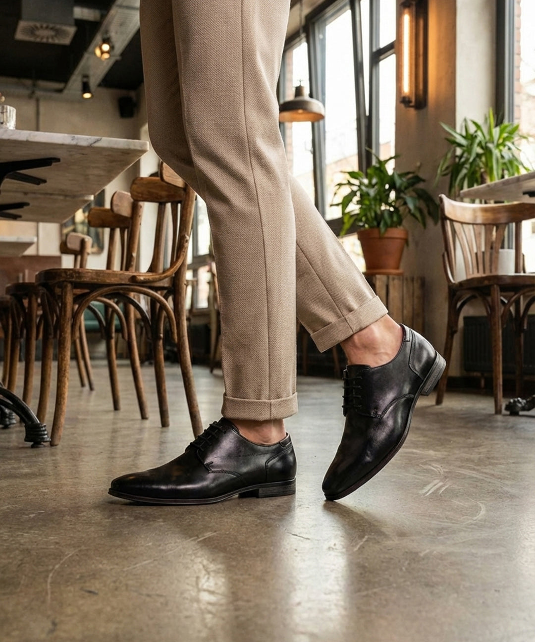 bugatti Margo black leather derby shoes with a lace-up closure and a sleek, formal design.
