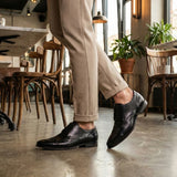bugatti Margo black leather derby shoes with a lace-up closure and a sleek, formal design.
