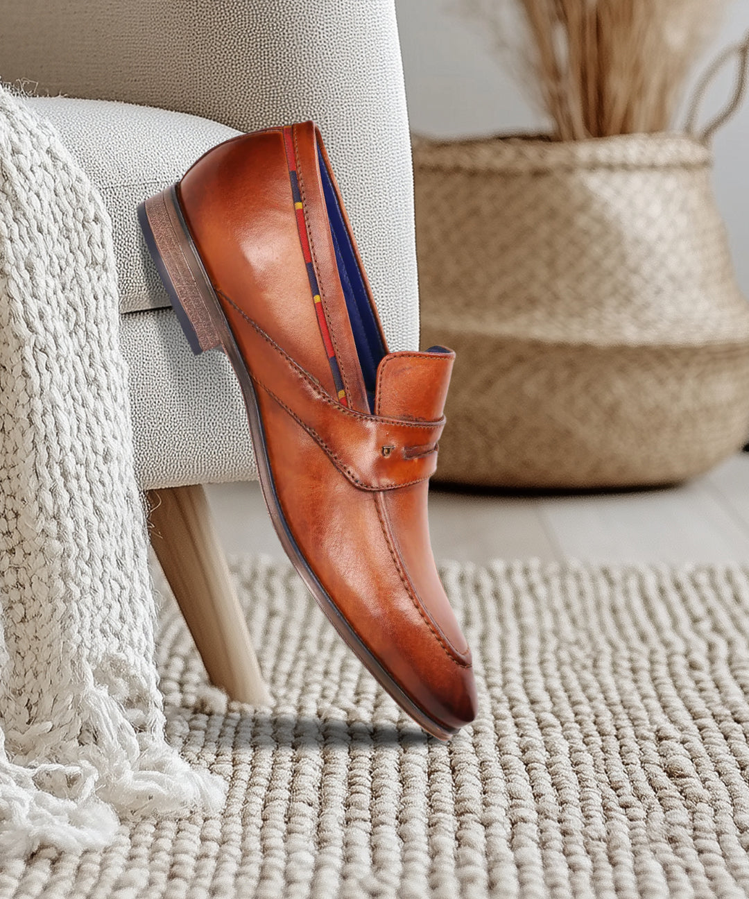 A cognac Men's bugatti Penny Loafer featuring a round toe apron toe, stacked heel. Made from premium genuine leather with a durable high quality synthetic outsole, this slip-on design offers both style and comfort.