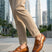 bugatti Sula Revo Yellow premium leather penny loafers, shown with khaki pants on a cityscape background.
