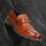 A cognac Men's bugatti Penny Loafer featuring a round apron toe, moulded  heel. Made from premium genuine leather with a durable tr outsole, this slip-on design offers both style and comfort.