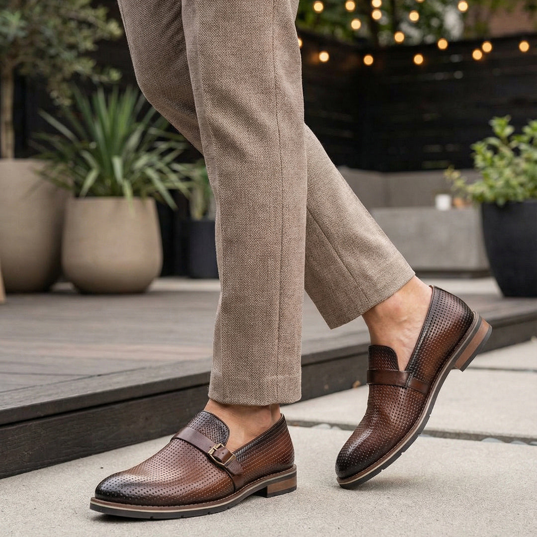 bugatti Laziano Revo Comfort premium brown leather penny loafers with decorative perforations and buckle.
